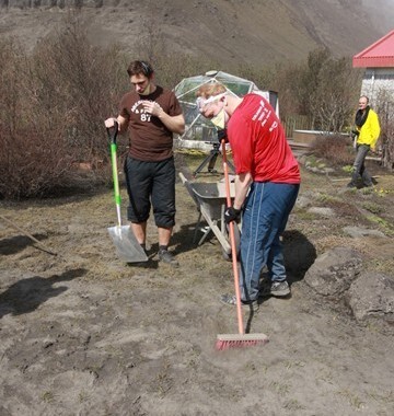 Cleaning the ash from Eyjafjallajokull eruption with brooms and shovels