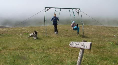 Girls on swings at Hornbjargsviti light house.