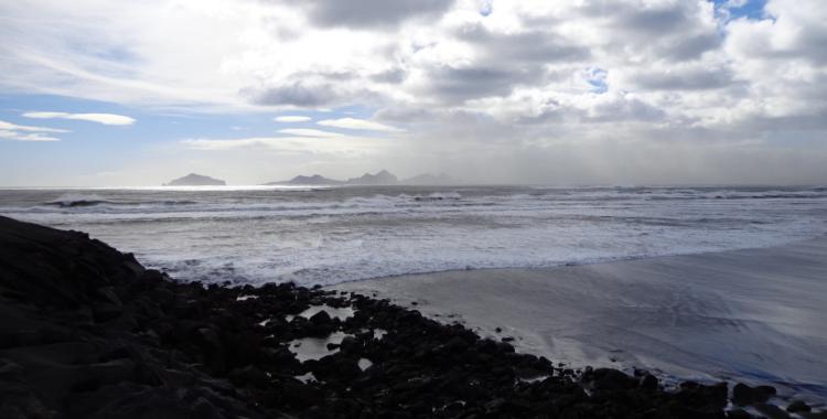 The Westman islands loom in the background as storm pounds the coast.