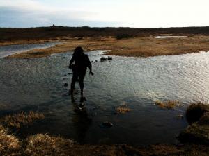 Going barefoot across the stones to reach the pool