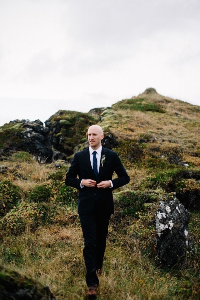 Groom looking very sharp in a lava field. 