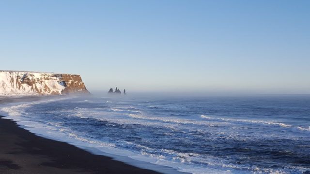 The view of Reynisfjara Black Beach from Dyrholaey promontory in Iceland.