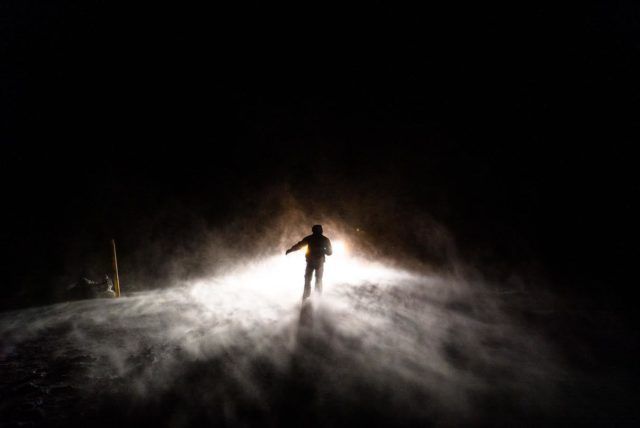 Surfer in a storm. It is time to go home. Photo by Chris Burkard. 