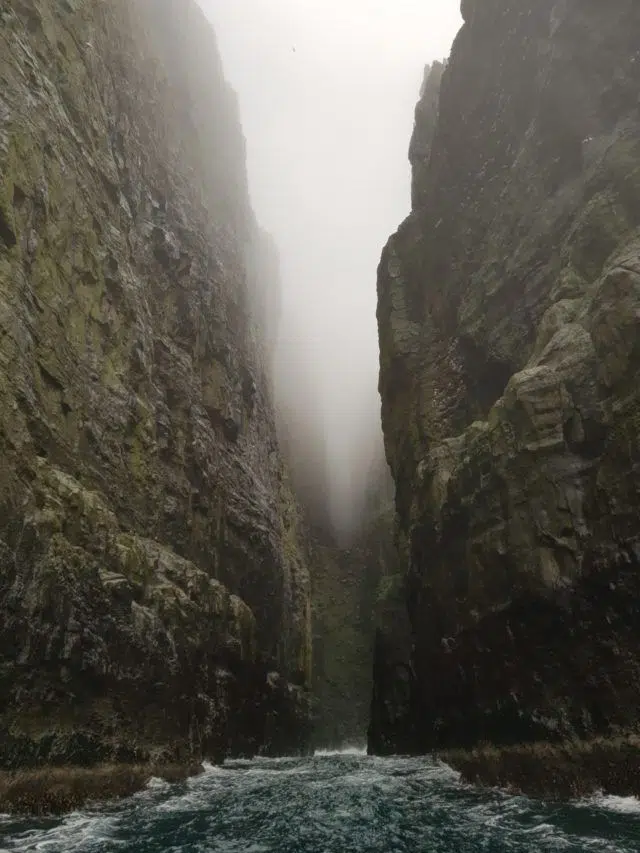 Entering a massive cave in the Faroese sea cliffs.