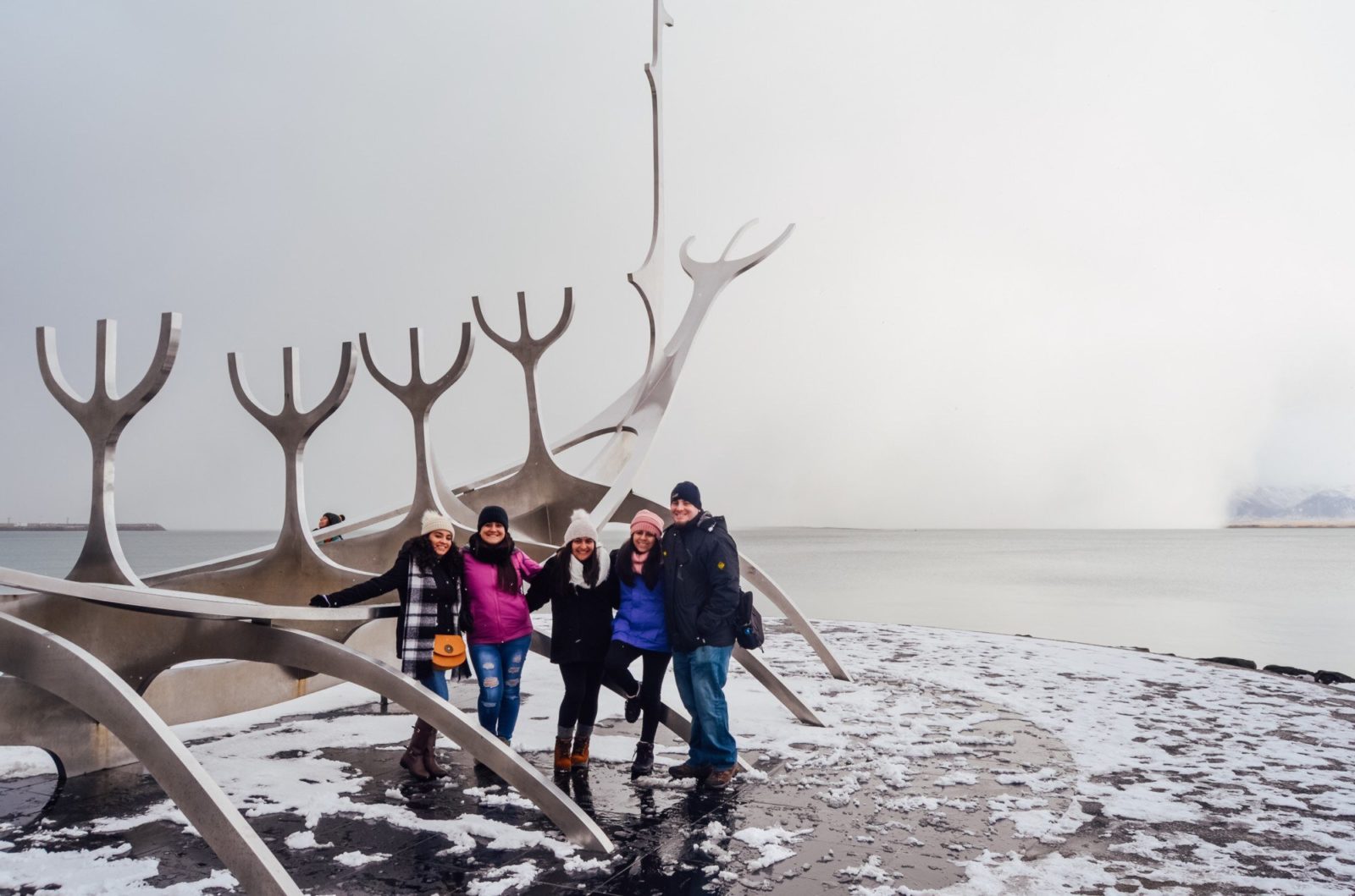 Four travelers by the Sólfar in Reykjavik.