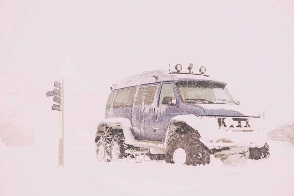 Truck in Icelandic winter with lots of snow. Educate yourself to travel safely in Iceland.