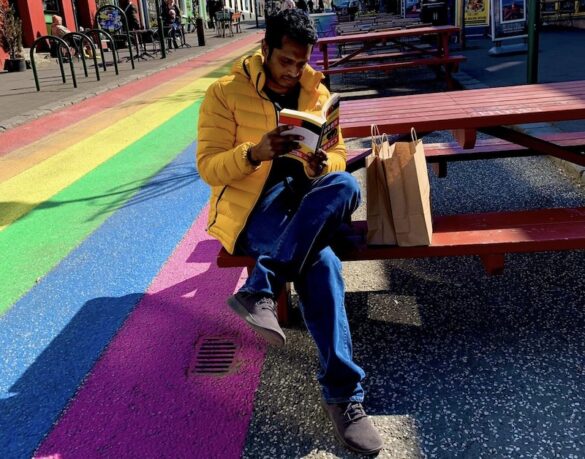 Abak Hussain is a writer and journalist from Bangladesh, here he is immersed in an Icelandic book in the rainbow road of Skólavörðustígur in Reykjavik.