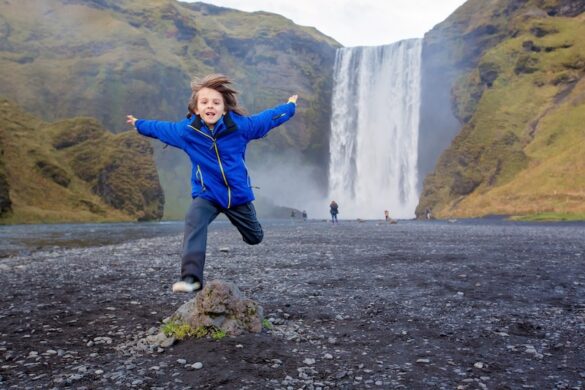 This kid loves running in front of waterfalls in Iceland, in this case, Skógafoss waterfall.