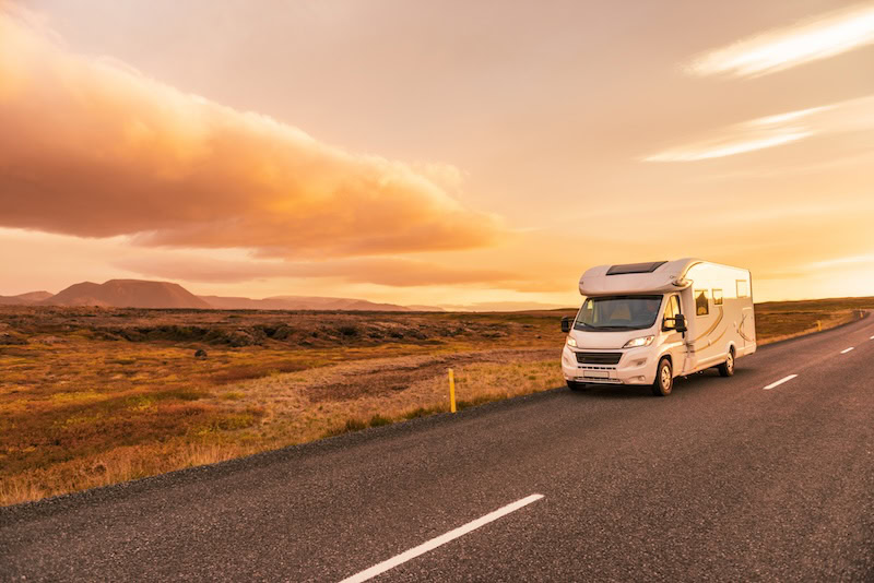 Camper van on the road on a highway in Iceland.