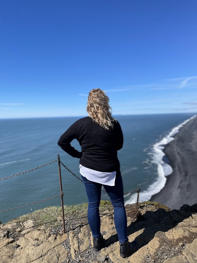 Travel sustainability expert María Guðjónsdóttir marvels at the view above Reynisfjara beach. 